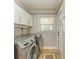 Bright laundry room features modern appliances, ample storage, and a convenient layout at 2908 Mayflower St, Sarasota, FL 34231