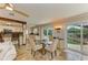 Bright living room with a ceiling fan, open to the dining area, and sliding doors to an outdoor area at 2908 Mayflower St, Sarasota, FL 34231