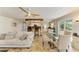 Open-concept living room and dining area with a ceiling fan, and sliding glass door to the outdoor area at 2908 Mayflower St, Sarasota, FL 34231