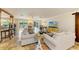 Open-concept living room with tile flooring, comfortable seating, and sliding glass doors to outdoor dining and pool at 2908 Mayflower St, Sarasota, FL 34231