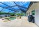 Beautiful pool area featuring a custom pool, hot tub, lush landscaping, and screened enclosure at 2908 Mayflower St, Sarasota, FL 34231