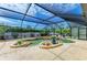 Gorgeous screened-in pool area with custom pool, hot tub, and mature landscaping at 2908 Mayflower St, Sarasota, FL 34231