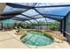Relaxing screened-in pool area with a custom pool, hot tub, and cozy seating area at 2908 Mayflower St, Sarasota, FL 34231