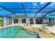 Stunning screened-in pool with a unique design, surrounded by a patio area perfect for lounging and outdoor dining at 2908 Mayflower St, Sarasota, FL 34231