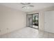 Bright bedroom with tile flooring, a ceiling fan, and sliding glass doors to the lanai at 314 Oak Hill Way # 24, Sarasota, FL 34232