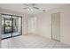Bright bedroom with tile flooring, ceiling fan, sliding glass doors to patio, and closet at 314 Oak Hill Way # 24, Sarasota, FL 34232