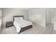 Well-lit bedroom featuring tiled floors, closet space, and a comfortable queen-sized bed with a nightstand at 314 Oak Hill Way # 24, Sarasota, FL 34232