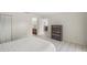 Well-lit bedroom featuring tiled floors, closet space, and an additional bureau for storage space at 314 Oak Hill Way # 24, Sarasota, FL 34232