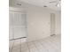 Bright bedroom with tile flooring, neutral-toned walls, and double-door closets at 314 Oak Hill Way # 24, Sarasota, FL 34232
