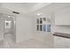 Sunlit breakfast nook with white cabinetry, shuttered windows, and tile flooring at 314 Oak Hill Way # 24, Sarasota, FL 34232