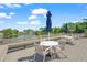 Waterfront community area with tables, chairs, and umbrellas overlooking a lake with a fountain at 314 Oak Hill Way # 24, Sarasota, FL 34232
