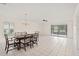 Open dining area with tile floors, chandelier, and access to a screened lanai at 314 Oak Hill Way # 24, Sarasota, FL 34232