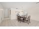 Formal dining room features a chandelier, tile flooring, and views to living areas at 314 Oak Hill Way # 24, Sarasota, FL 34232