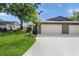 Attractive home with a two-car garage, tidy lawn and landscaping, showcasing curb appeal at 314 Oak Hill Way # 24, Sarasota, FL 34232
