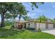 Charming home featuring a two-car garage, lush landscaping, and a well-manicured lawn at 314 Oak Hill Way # 24, Sarasota, FL 34232