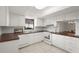 Clean kitchen with white cabinets, tile flooring, and views into the adjoining dining area at 314 Oak Hill Way # 24, Sarasota, FL 34232