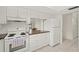 Kitchen with white appliances, cabinetry, and view into dining area at 314 Oak Hill Way # 24, Sarasota, FL 34232