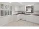 Well-lit kitchen with white cabinetry, subway tile backsplash and neutral tile floors at 314 Oak Hill Way # 24, Sarasota, FL 34232