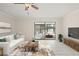 Bright living room with neutral walls, tile flooring, and sliding glass doors to an enclosed porch at 314 Oak Hill Way # 24, Sarasota, FL 34232