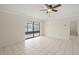 Open living room features tiled floors, neutral walls, and sliding glass doors to an enclosed porch at 314 Oak Hill Way # 24, Sarasota, FL 34232