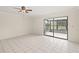 Living room featuring tiled floors, neutral walls, and sliding glass doors to an enclosed porch at 314 Oak Hill Way # 24, Sarasota, FL 34232