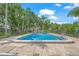 A refreshing community pool surrounded by palm trees and lounge chairs at 314 Oak Hill Way # 24, Sarasota, FL 34232