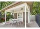 Covered outdoor seating area with a table, chairs, and access to community restrooms at 314 Oak Hill Way # 24, Sarasota, FL 34232