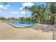 Community pool surrounded by lounge chairs and lush landscaping at 314 Oak Hill Way # 24, Sarasota, FL 34232
