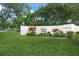 Community sign for Village Oaks, surrounded by lush landscaping and manicured lawn at 314 Oak Hill Way # 24, Sarasota, FL 34232