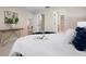 Cozy bedroom featuring soft bedding, a console table, and serene decor, inviting relaxation and comfort at 3360 Tallywood Ct # 7082, Sarasota, FL 34237