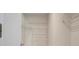Organized walk-in closet with shelving, optimizing storage and accessibility for a tidy and efficient space at 3360 Tallywood Ct # 7082, Sarasota, FL 34237