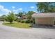 Charming exterior with carport, green lawn, and mature trees at 3360 Tallywood Ct # 7082, Sarasota, FL 34237