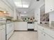 Well-lit kitchen with white cabinets, granite countertops, and modern appliances at 3360 Tallywood Ct # 7082, Sarasota, FL 34237