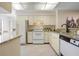 Functional kitchen featuring neutral cabinets and granite countertops with updated appliances at 3360 Tallywood Ct # 7082, Sarasota, FL 34237