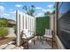 Cozy outdoor patio features neutral furniture, privacy fence, and brick flooring at 3360 Tallywood Ct # 7082, Sarasota, FL 34237