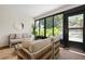 Serene sunroom featuring natural light, lush greenery, and cozy furnishings, creating a tranquil and inviting space at 3360 Tallywood Ct # 7082, Sarasota, FL 34237