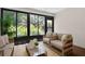 Bright sunroom with large windows, comfortable seating, seamlessly blending indoor comfort with outdoor views at 3360 Tallywood Ct # 7082, Sarasota, FL 34237