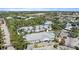 Community featuring various buildings, a pool, and tropical trees within a securely gated entrance at 3405 54Th W Dr # 102, Bradenton, FL 34210
