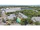 Overhead shot showing a pool, community building, tennis courts, and ample parking surrounded by greenery at 3405 54Th W Dr # 102, Bradenton, FL 34210