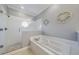 Bright bathroom featuring a walk-in shower with window and a soaking tub at 3405 54Th W Dr # 102, Bradenton, FL 34210