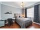 Stylized bedroom with a full sized bed, a work space, wood floors, and modern decor at 3405 54Th W Dr # 102, Bradenton, FL 34210