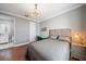 This bedroom features hardwood floors, a light fixture and access to the ensuite bathroom at 3405 54Th W Dr # 102, Bradenton, FL 34210