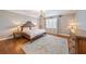 This bedroom features wood floors, a light fixture, and ample natural light at 3405 54Th W Dr # 102, Bradenton, FL 34210