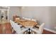 Bright dining area features a stylish dining table set, hardwood floors, and neutral wall paint at 3405 54Th W Dr # 102, Bradenton, FL 34210