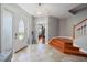 Welcoming foyer with tile flooring, staircase, and view into living space providing a bright entrance at 3405 54Th W Dr # 102, Bradenton, FL 34210