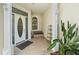 Inviting front entrance features tiled flooring, a bench, and elegant details on the door and pillars at 3405 54Th W Dr # 102, Bradenton, FL 34210
