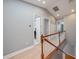 Upstairs hallway showcasing wood floors, white trim, and doors leading to various rooms at 3405 54Th W Dr # 102, Bradenton, FL 34210