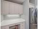Bright kitchen corner includes a built-in desk area with drawers, cabinets, and stainless steel refrigerator at 3405 54Th W Dr # 102, Bradenton, FL 34210