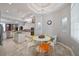 Bright kitchen features a round dining table with colorful chairs beneath a decorative chandelier at 3405 54Th W Dr # 102, Bradenton, FL 34210