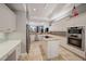 Bright kitchen with stainless steel appliances, an island cooktop and built-in oven, offering space and functionality at 3405 54Th W Dr # 102, Bradenton, FL 34210